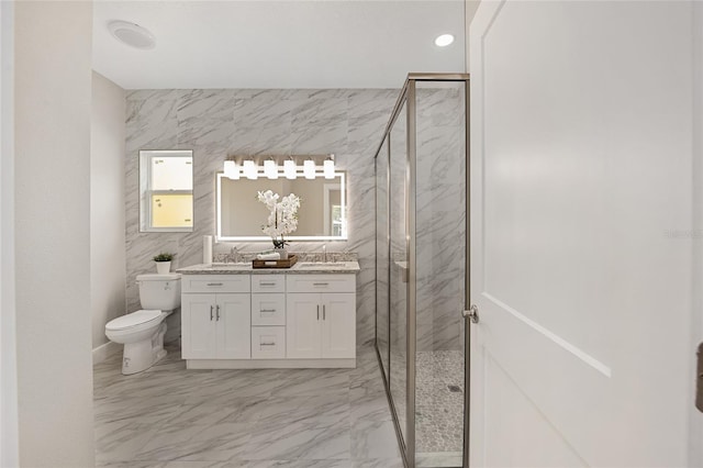 bathroom featuring vanity, a shower with shower door, and toilet