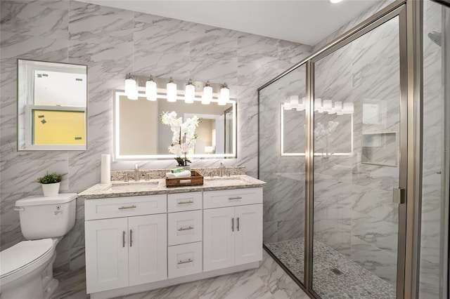 bathroom with an enclosed shower, vanity, toilet, and tile walls