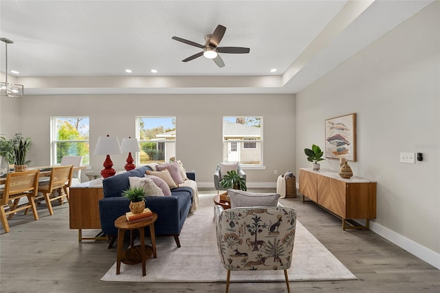 living room with light wood-type flooring and ceiling fan