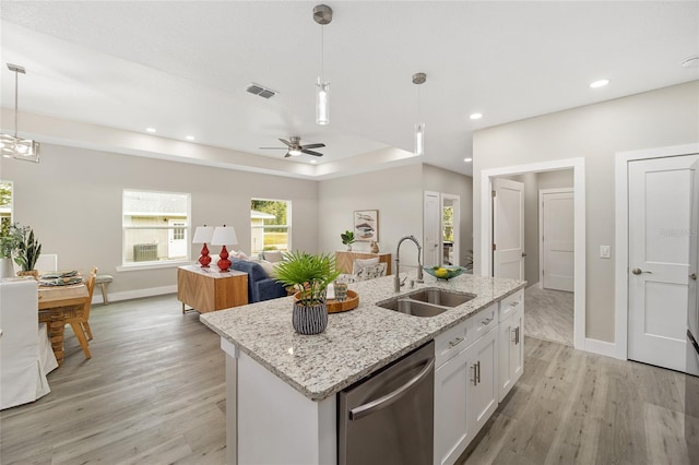 kitchen featuring sink, pendant lighting, dishwasher, light hardwood / wood-style floors, and white cabinetry