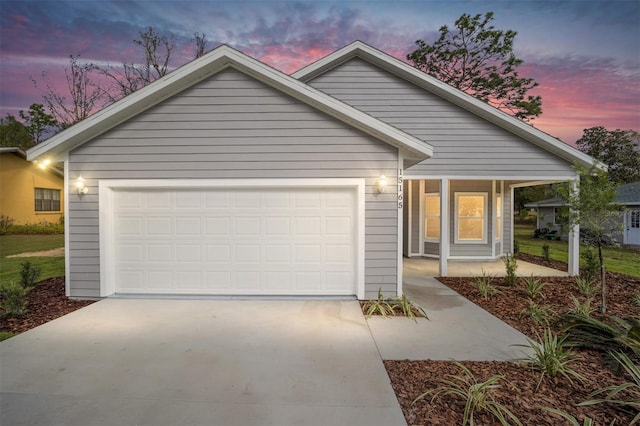 view of front of property featuring a porch and a garage