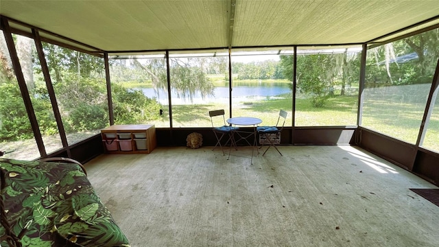 unfurnished sunroom featuring a water view