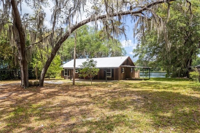 exterior space featuring a front lawn and an outbuilding