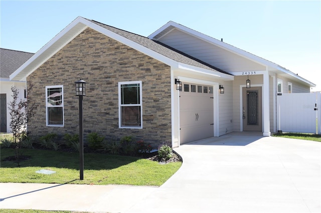 view of front of property featuring a front yard and a garage