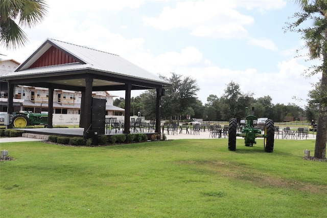 surrounding community with a gazebo and a yard