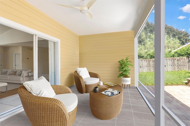 sunroom featuring ceiling fan