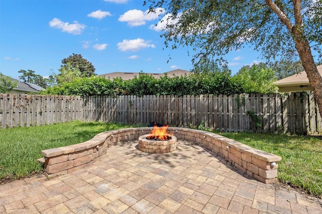 view of patio / terrace with fence and a fire pit