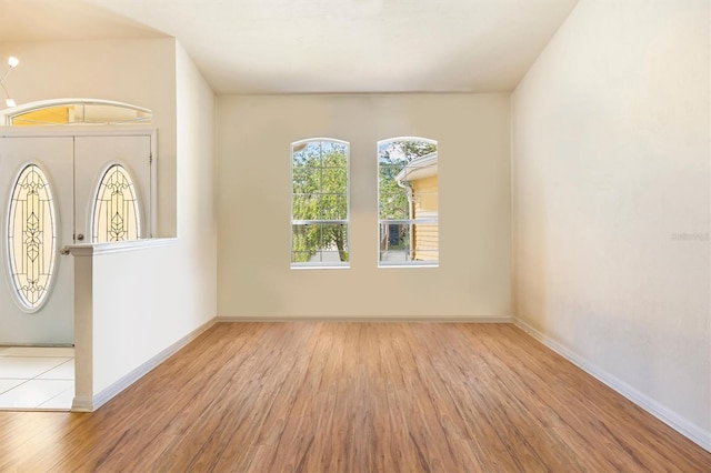 interior space featuring baseboards and wood finished floors