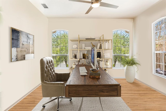 office space featuring visible vents, ceiling fan, baseboards, and wood finished floors