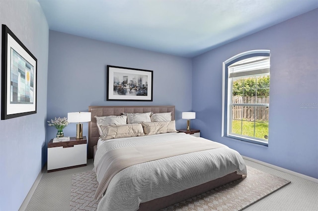 carpeted bedroom featuring baseboards