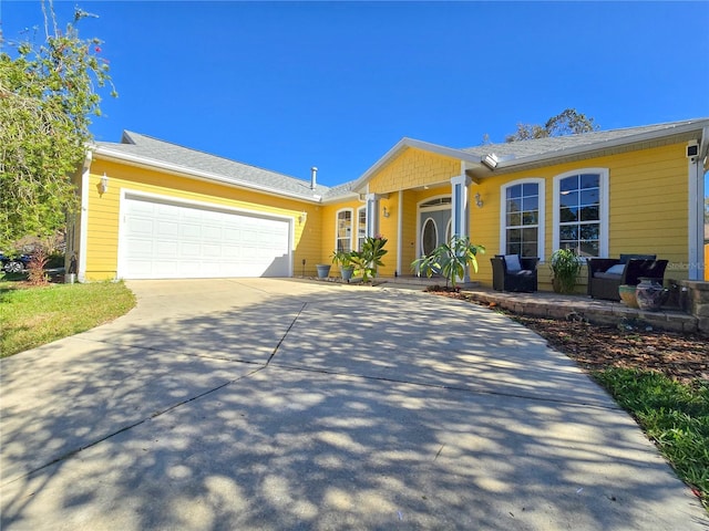 single story home featuring a garage and concrete driveway