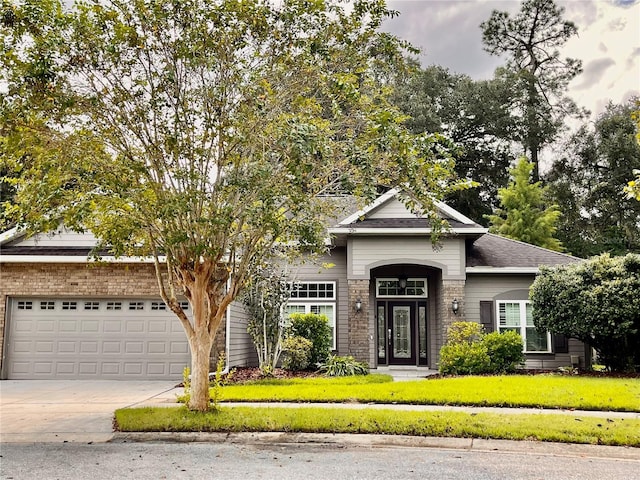 view of front of house featuring a front lawn and a garage