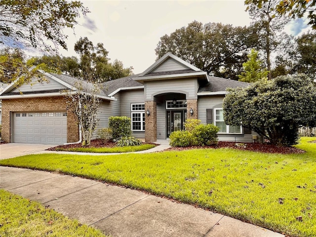 view of front of property featuring a garage and a front lawn