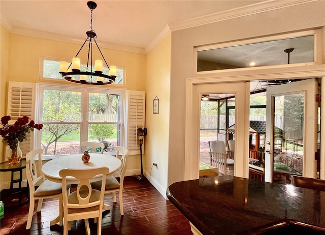 dining room with ornamental molding, a wealth of natural light, a chandelier, and dark hardwood / wood-style floors