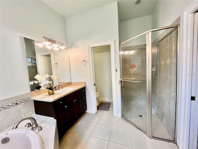 full bathroom featuring vanity, tile patterned flooring, toilet, and shower with separate bathtub