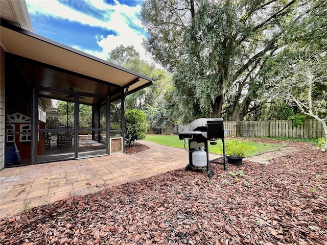 view of yard with a sunroom and a patio