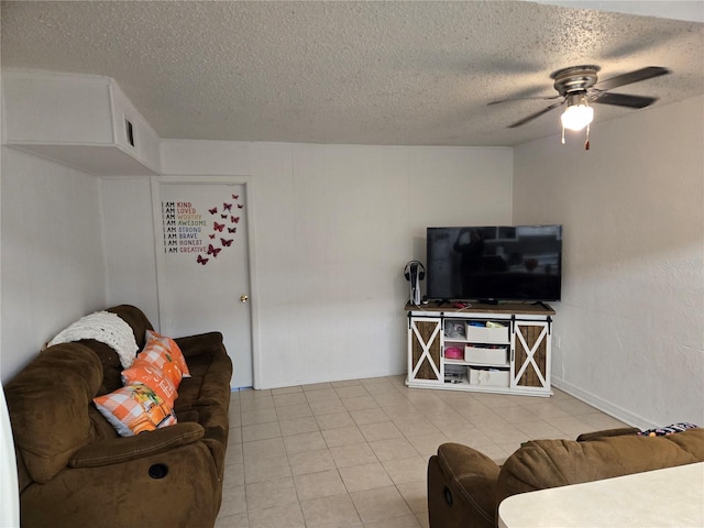 tiled living room featuring a textured ceiling and ceiling fan