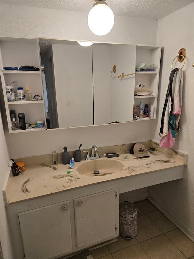 bathroom with vanity, a textured ceiling, and tile patterned floors