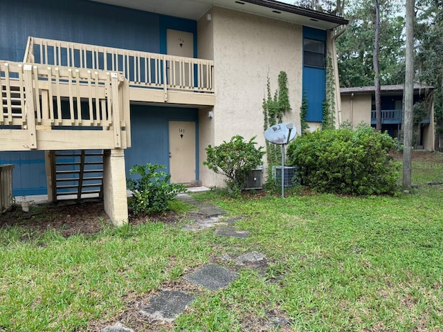 exterior space featuring a balcony and a yard