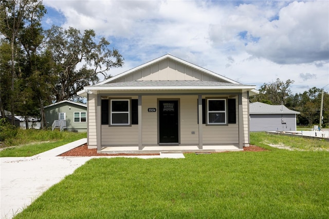 bungalow-style home with a front lawn