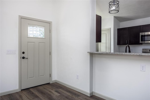 entryway featuring dark hardwood / wood-style floors and sink