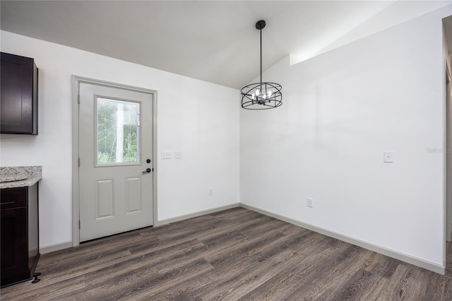 unfurnished dining area with lofted ceiling, a chandelier, and dark hardwood / wood-style floors