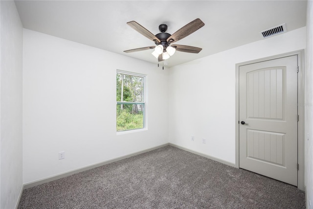 empty room with ceiling fan, baseboards, carpet flooring, and visible vents