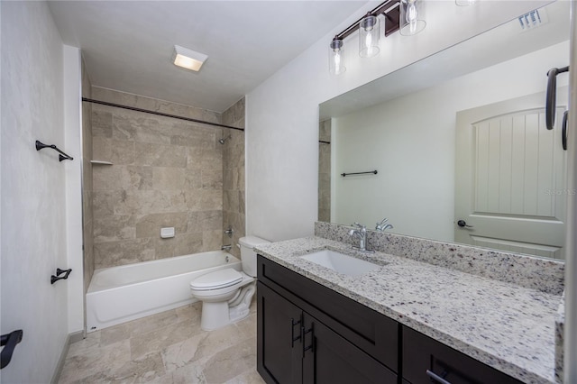 full bathroom featuring tiled shower / bath, vanity, and toilet