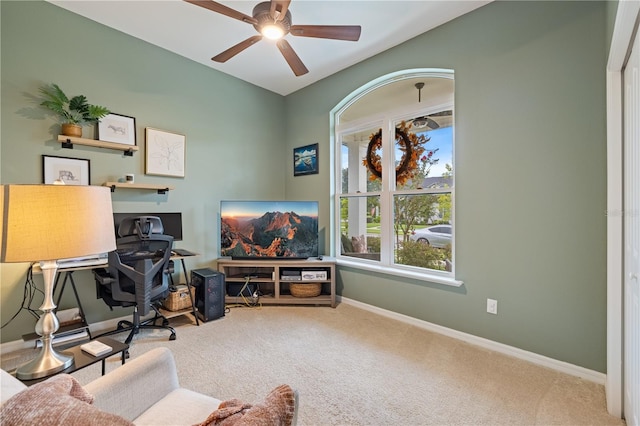 carpeted office space with ceiling fan