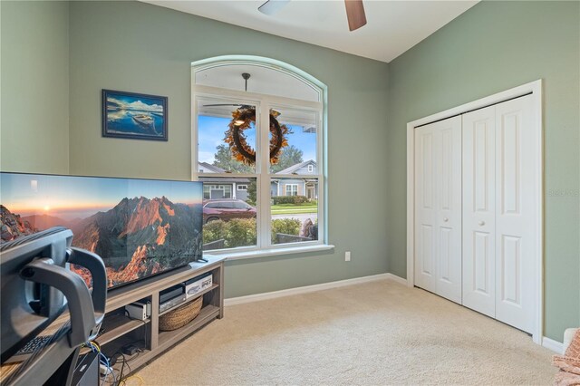 living area with ceiling fan and light colored carpet