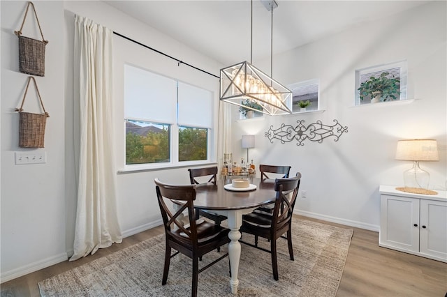 dining area featuring light hardwood / wood-style flooring and a chandelier