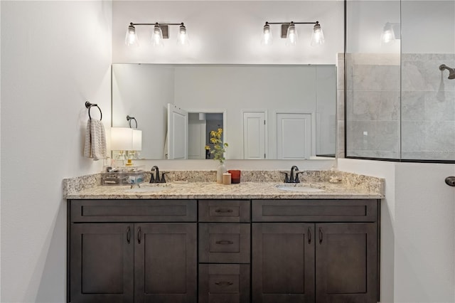 bathroom with walk in shower and vanity