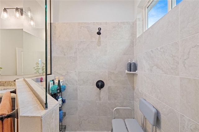 bathroom with vanity and a tile shower