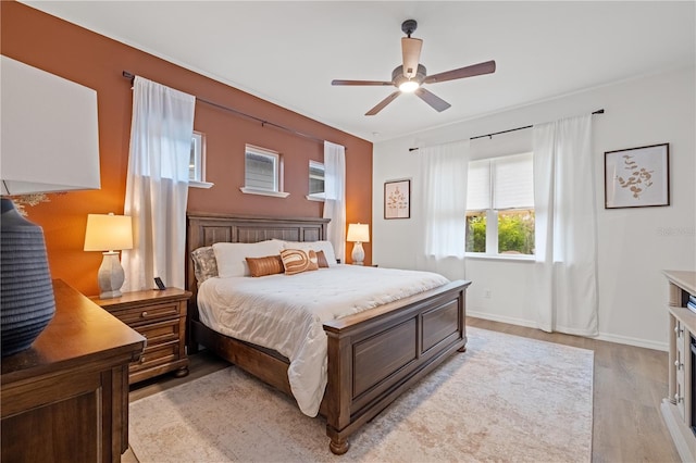 bedroom featuring light hardwood / wood-style floors and ceiling fan