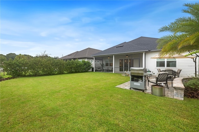 back of property featuring a sunroom, a lawn, and a patio area