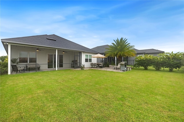 back of property featuring a lawn and a patio