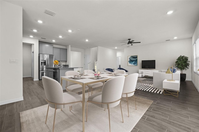 dining space featuring ceiling fan and dark hardwood / wood-style floors