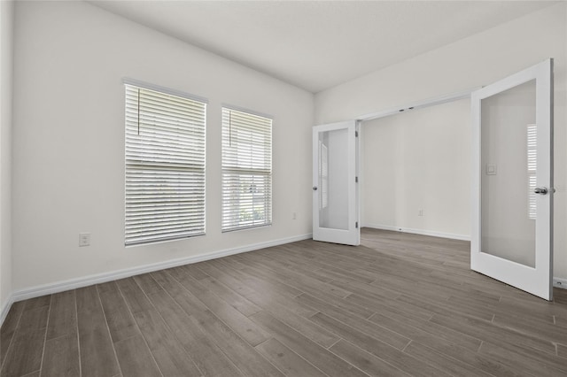 unfurnished bedroom featuring french doors and dark hardwood / wood-style floors