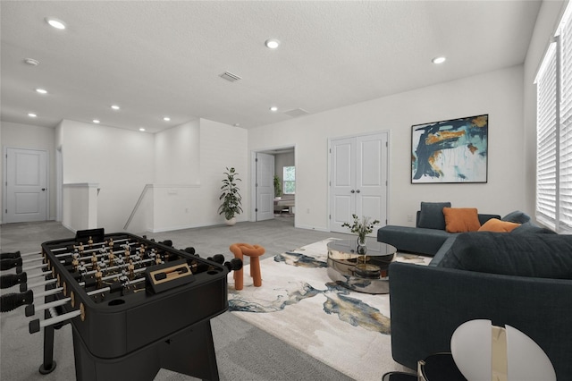 carpeted living room featuring a textured ceiling