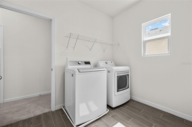 clothes washing area featuring separate washer and dryer and hardwood / wood-style floors