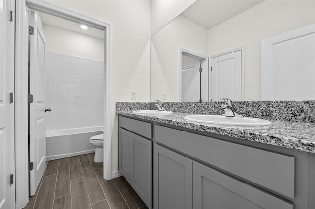 full bathroom featuring shower / bathing tub combination, vanity, and toilet