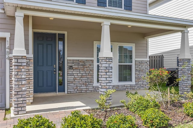 view of exterior entry featuring a porch