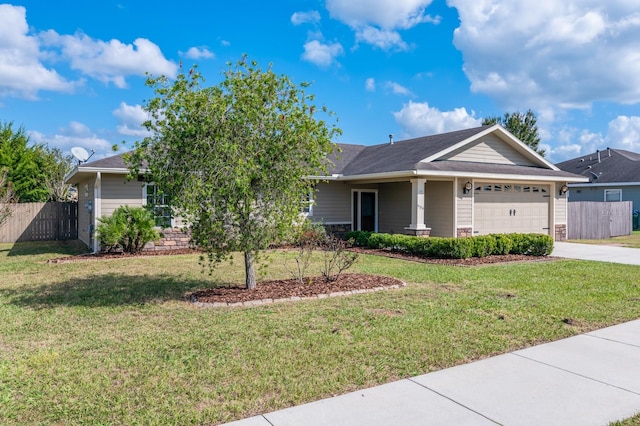 view of front of home with a front yard and a garage