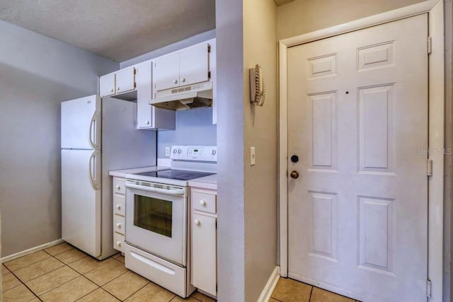 kitchen featuring white cabinetry, light tile patterned floors, a textured ceiling, and white appliances