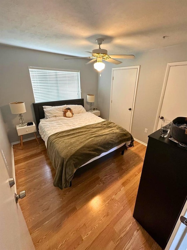 bedroom featuring ceiling fan and hardwood / wood-style floors