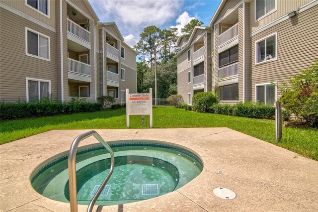4000 SW 23rd St Unit 3-108, Gainesville, FL 32608 - view of swimming pool with a lawn and a community hot tub