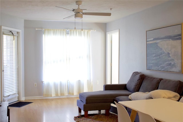 living room with hardwood / wood-style floors and ceiling fan