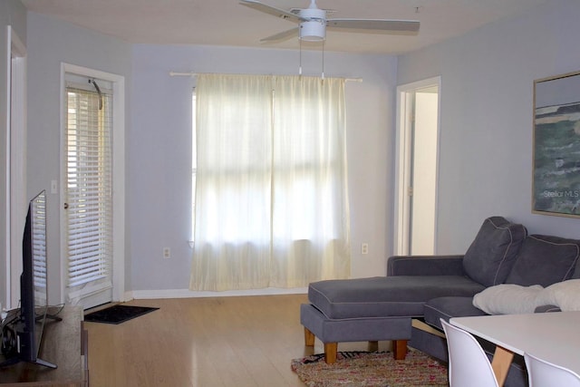 living room with hardwood / wood-style floors, a wealth of natural light, and ceiling fan