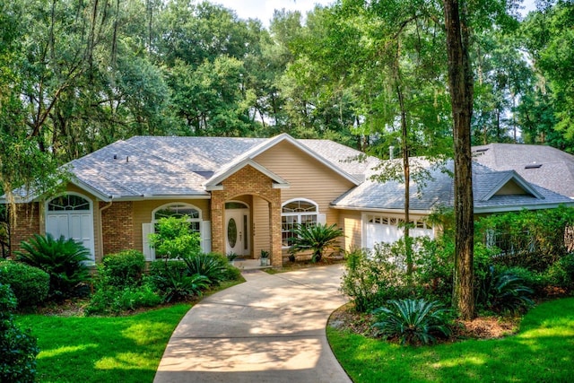 ranch-style home featuring a garage and a front lawn