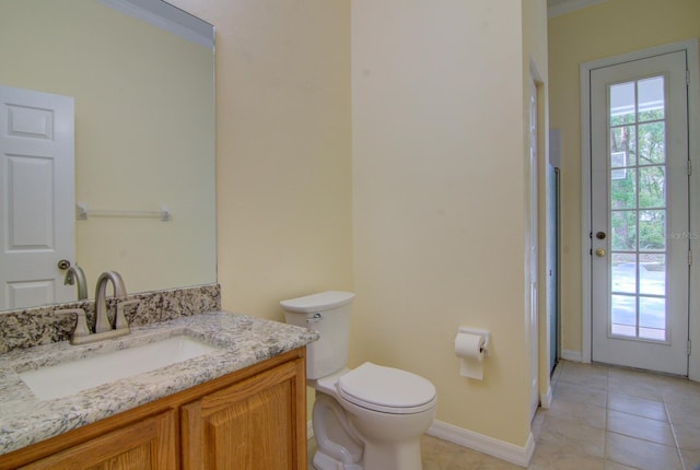 bathroom with crown molding, tile patterned flooring, vanity, and toilet